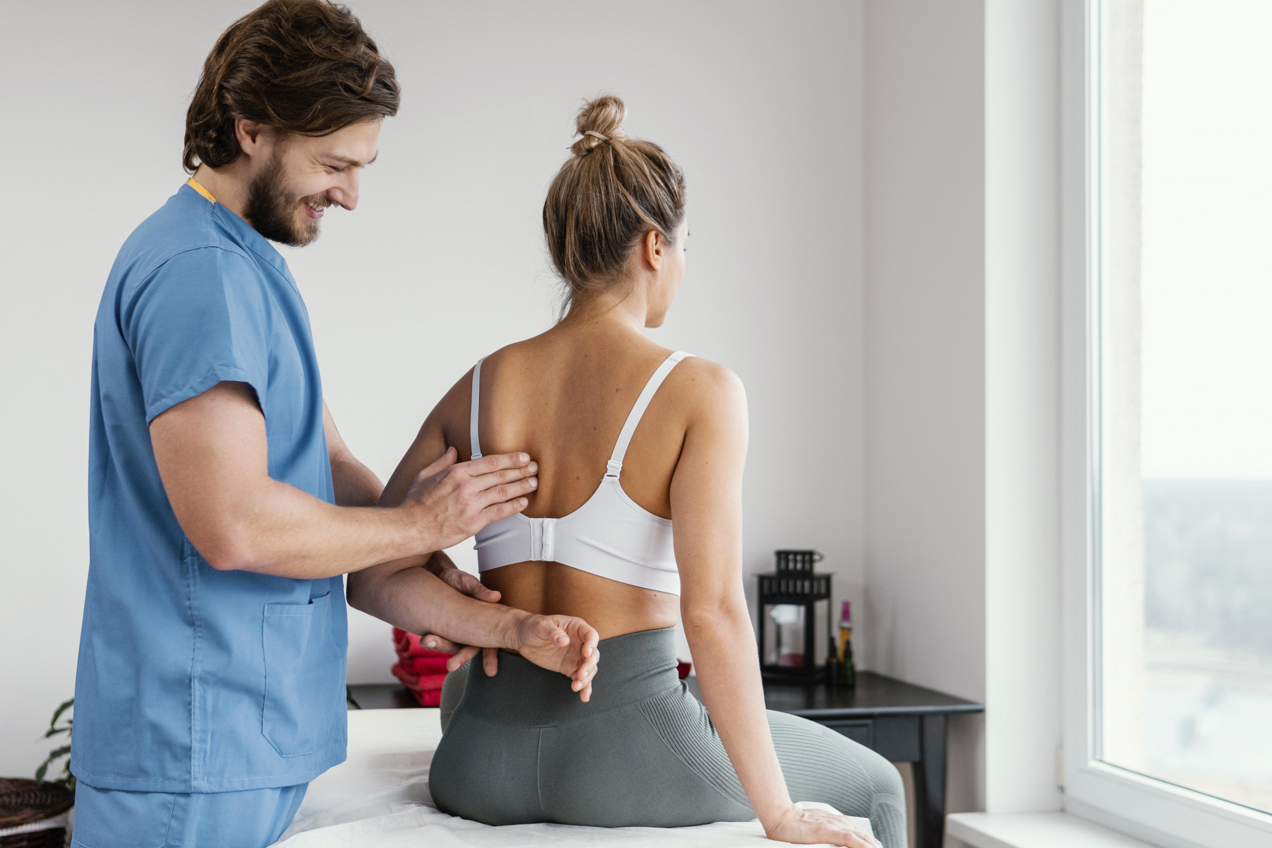 male-osteopathic-therapist-checking-female-patient-s-scapula-bone